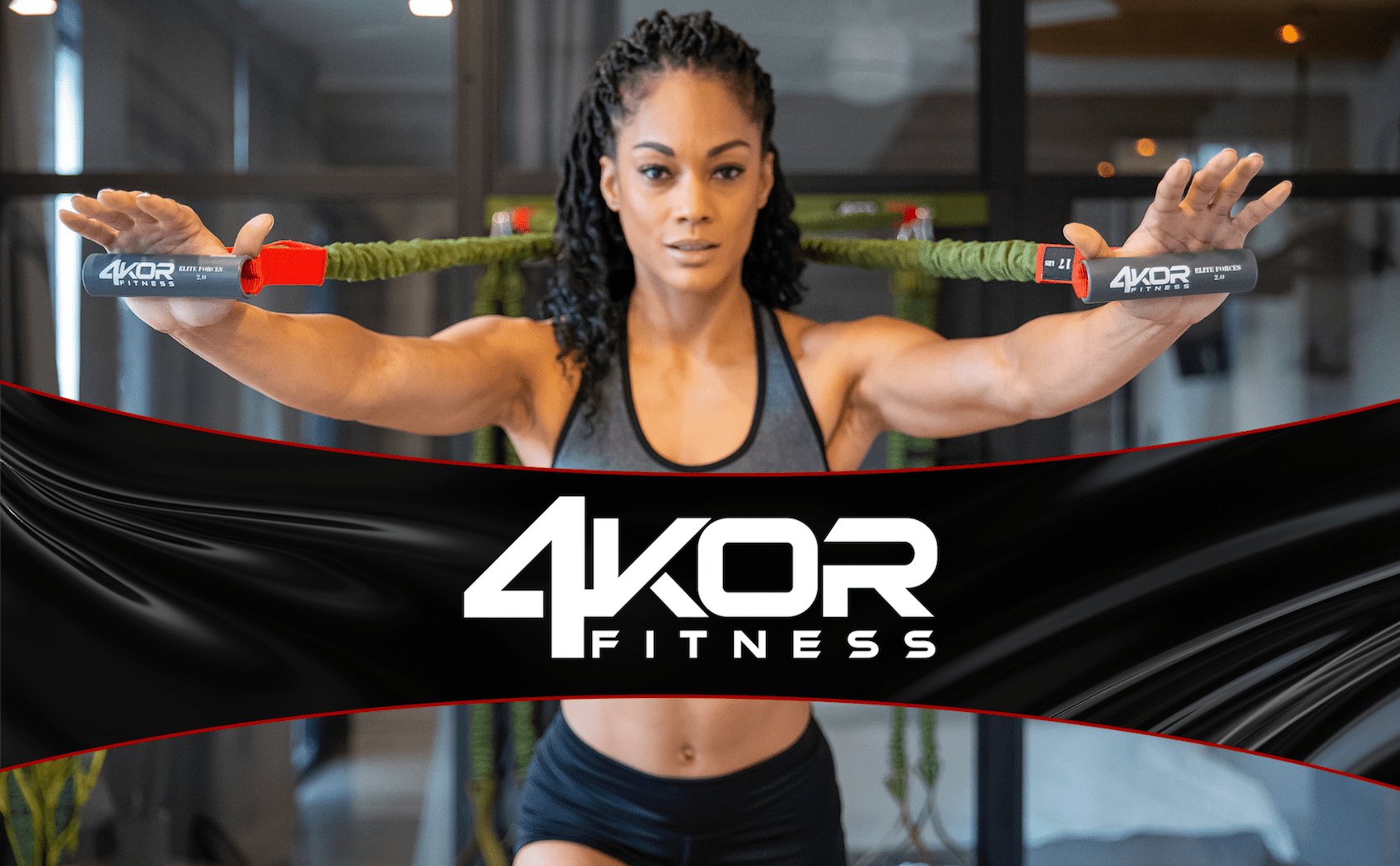 Muscular female in gray tank holding cord handles extended to sides in dark gym, large 4KOR Fitness logo banner